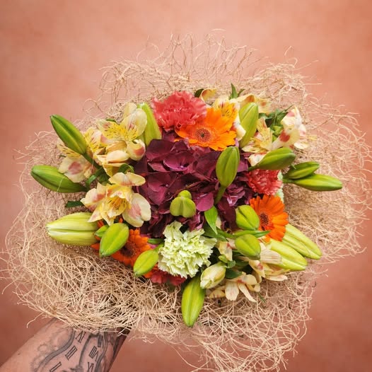 Bouquet rond aux tons orangés et bordeaux